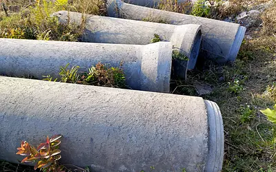 Large concrete drainage pipes lying on the ground
