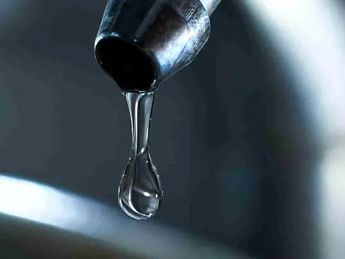 Water dripping from a chrome tap spout
