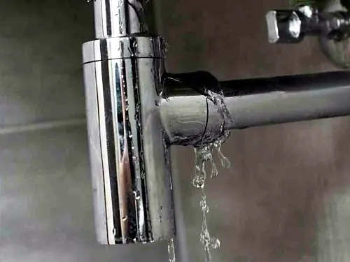 Water leaking from a joint on a chrome basin bottle trap